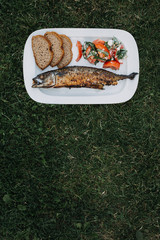 Grilled mackerel with 100% rie bread slices and tomato salad with feta cheese and organic basil leaves