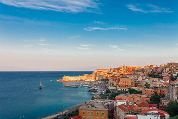Fototapeta na wymiar Panoramic sea landscape with Gaeta, Lazio, Italy. Scenic historical town with old buildings, ancient churches, nice sand beach and clear blue water. Famous tourist destination in Riviera de Ulisse