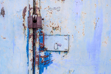 Padlock on an old metal door