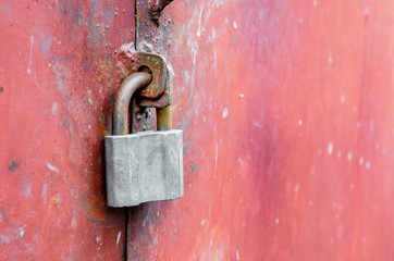 Padlock on an old metal door