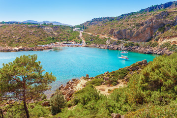 Fototapeta na wymiar Sea skyview landscape photo Ladiko bay near Anthony Quinn bay on Rhodes island, Dodecanese, Greece. Panorama with nice sand beach and clear blue water. Famous tourist destination in South Europe