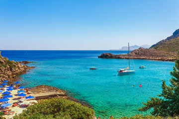 Fototapeta na wymiar Sea skyview landscape photo Anthony Quinn bay near Ladiko bay on Rhodes island, Dodecanese, Greece. Panorama with nice sand beach and clear blue water. Famous tourist destination in South Europe