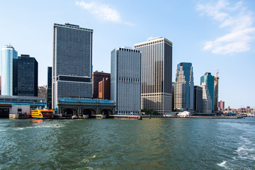 New York City / USA - JUL 14 2018: Lower Manhattan Skyline view from Governors Island ferry on a clear afternoon