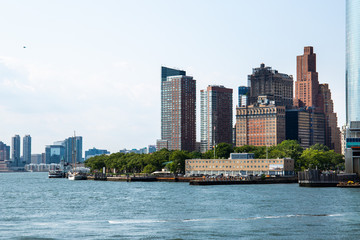 Naklejka premium New York City / USA - JUL 14 2018: Lower Manhattan Skyline view from Governors Island ferry on a clear afternoon