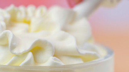 Swirls of whipped cream, macro closeup preparation for cake decorating.