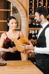 wine steward giving consultation to female client at wine store