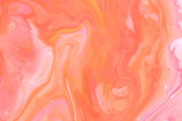 Multicolored holographic background, orange liquid spills, multicolored pattern, food colors in milk, color texture on the water, blank for the designer