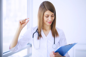 Clinic. Cheerful Doctor working at her office