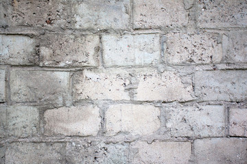 old wall of gray concrete blocks, background texture