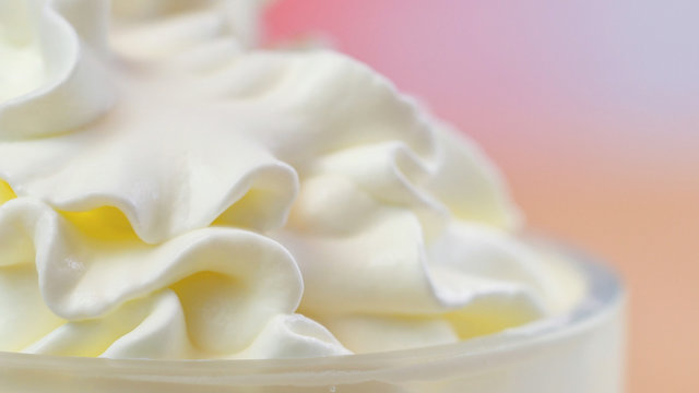 Swirls of whipped cream, macro closeup preparation for cake decorating.