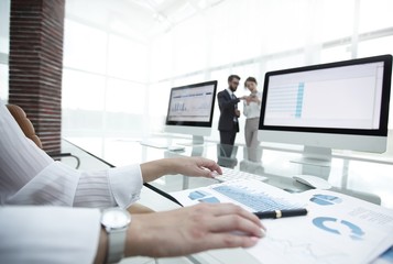 close-up of a business woman working with financial charts in a modern office