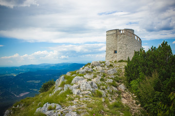 soft focus old medieval tower on top of high mountain nature landscape concept in colorful summer gray rainy day time 