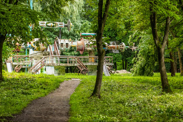 devastation and decay concept old poor rusty and broken carousel in outdoor green park environment in one of past ussr  counties 
