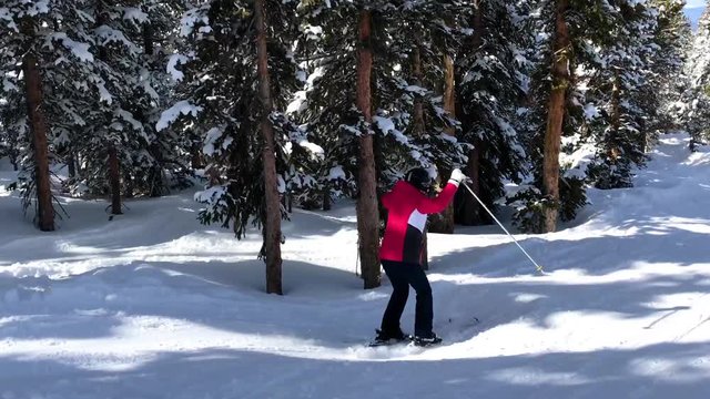 Woman tree skiing and jumping ramps 