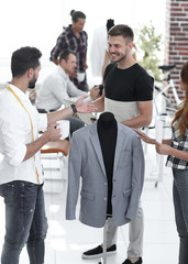 group of designers discuss men's suit