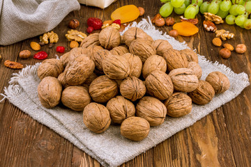 Closed walnuts on wooden background
