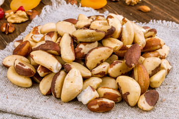 Tasty brasil nuts on wooden background