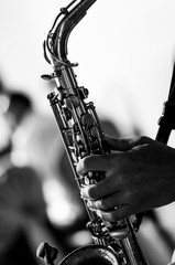saxophone in the musician's hand. Black and white photography