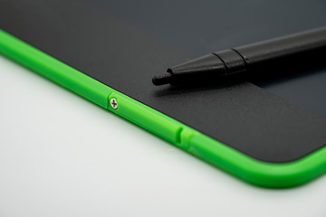 Black and green LCD writing pad tablet isolated on white