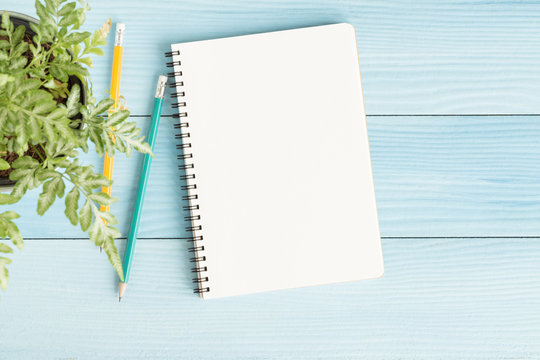Blank notebook with and pencil on blue background,Flat lay photo of notebook for your message