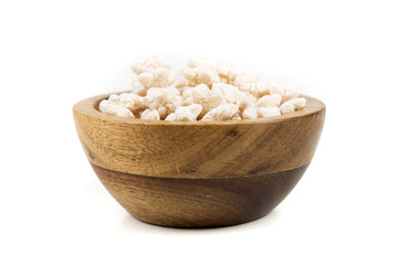 Piles of pale whole grain children's puffed cereal snack