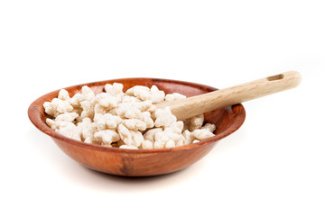 Piles of pale whole grain children's puffed cereal snack