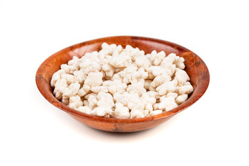 Piles of pale whole grain children's puffed cereal snack