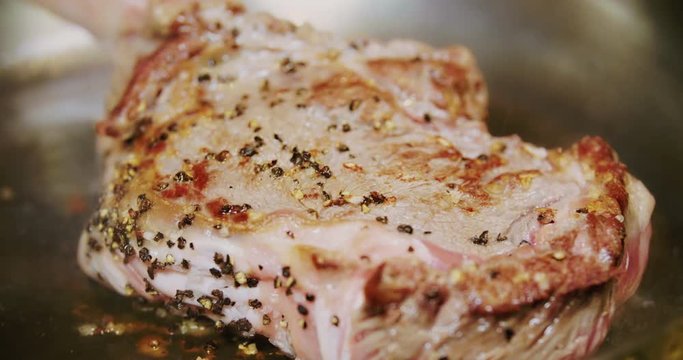 Professional chef is preparing steak in a modern restaurant