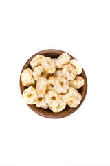 Piles of pale whole grain children's puffed cereal snack