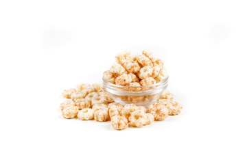 Piles of pale whole grain children's puffed cereal snack