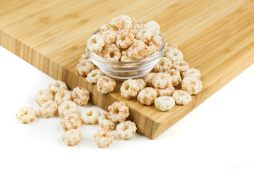 Piles of pale whole grain children's puffed cereal snack