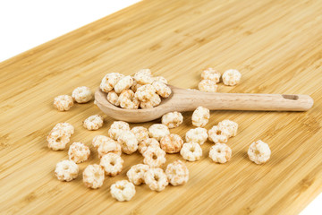 Piles of pale whole grain children's puffed cereal snack