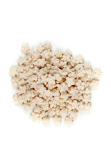 Piles of pale whole grain children's puffed cereal snack