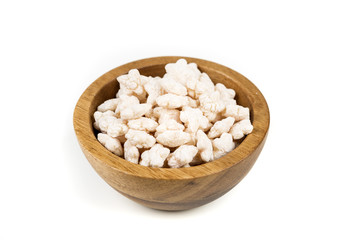 Piles of pale whole grain children's puffed cereal snack