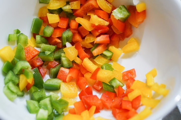 Beautiful red  yellow and green Sweet Pepper in white dish for cooking Omelet.