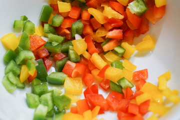 Beautiful red  yellow and green Sweet Pepper in white dish for cooking Omelet.