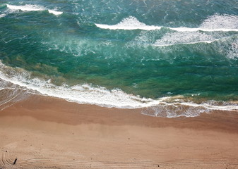 Top view aerial photo from flying drone of beauty nature landscape turquoise water with Wanda beach in winter day in Cronulla. Amazing seascape with waves and walking people. Travel vacation concept.