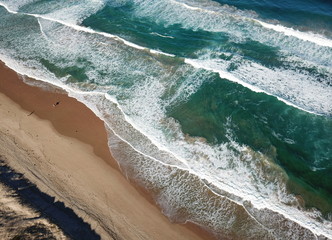 Top view aerial photo from flying drone of beauty nature landscape turquoise water with Wanda beach in winter day in Cronulla. Amazing seascape with waves and walking people. Travel vacation concept.