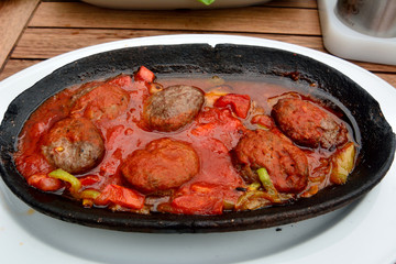 Turkish kofte with tomato sauce.
