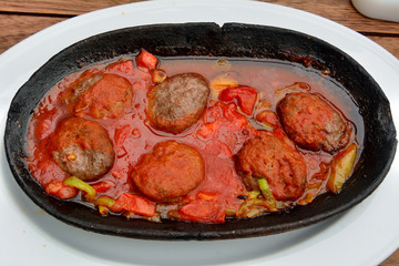 Turkish kofte with tomato sauce.