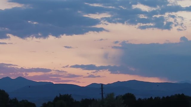 Colorado Rocky Mountains orange and blue sunset with clouds time lapse