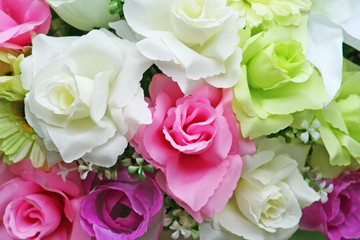 Beautiful muticolored artificial rose  flowers pink white green colorful on background