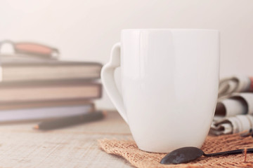 cup and book on wooden.