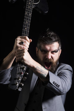 Music festival. Angry man with guitar at music festival. Bearded man shout at music festival. Punk rock festival. If the music is too loud you are too old