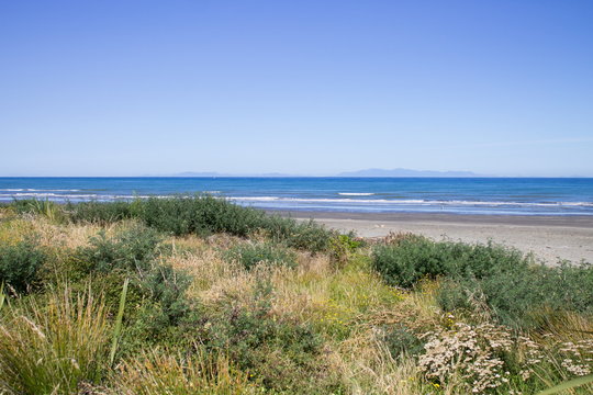 Landscape view from Paraparaumu Beach in Kapiti, Wellington, looking out across the Tasman Sea to the South Island of New Zealand.