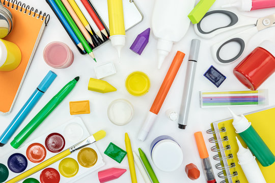 bright stationary items for school on white desk background
