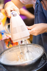 whipped cream cooking process.woman mixing Fresh cream for making whipped cream or desserts and bekery.woman making whipped cream and show process with stand or hand mixer.