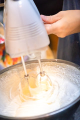 whipped cream cooking process.woman mixing Fresh cream for making whipped cream or desserts and bekery.woman making whipped cream and show process with stand or hand mixer.