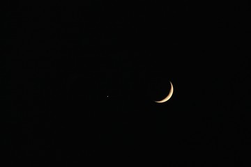 Obraz na płótnie Canvas Waxing Crescent Moon next to Venus, the evening star, at night