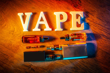 Popular vaping device mod. vape. vape smoke. The electronic cigarette is on the table. Liquids for...